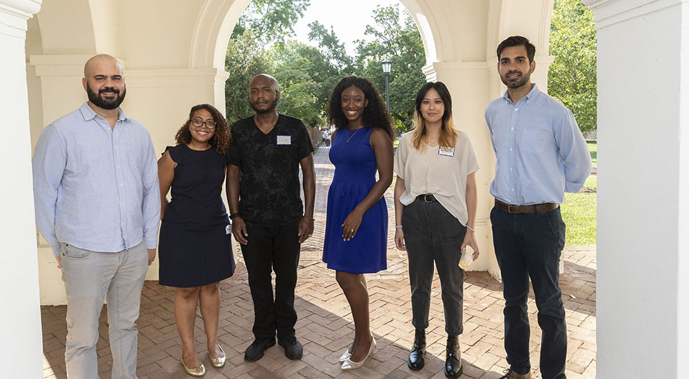 A group of six Race Place and Equity Postdoctoral Fellows standing at the entrance to the UVA Rotunda.